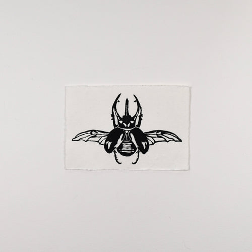 Hand-printed black and white linocut art of an Atlas beetle, unframed