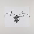 Hand-printed black and white linocut art of a giant harlequin beetle, unframed