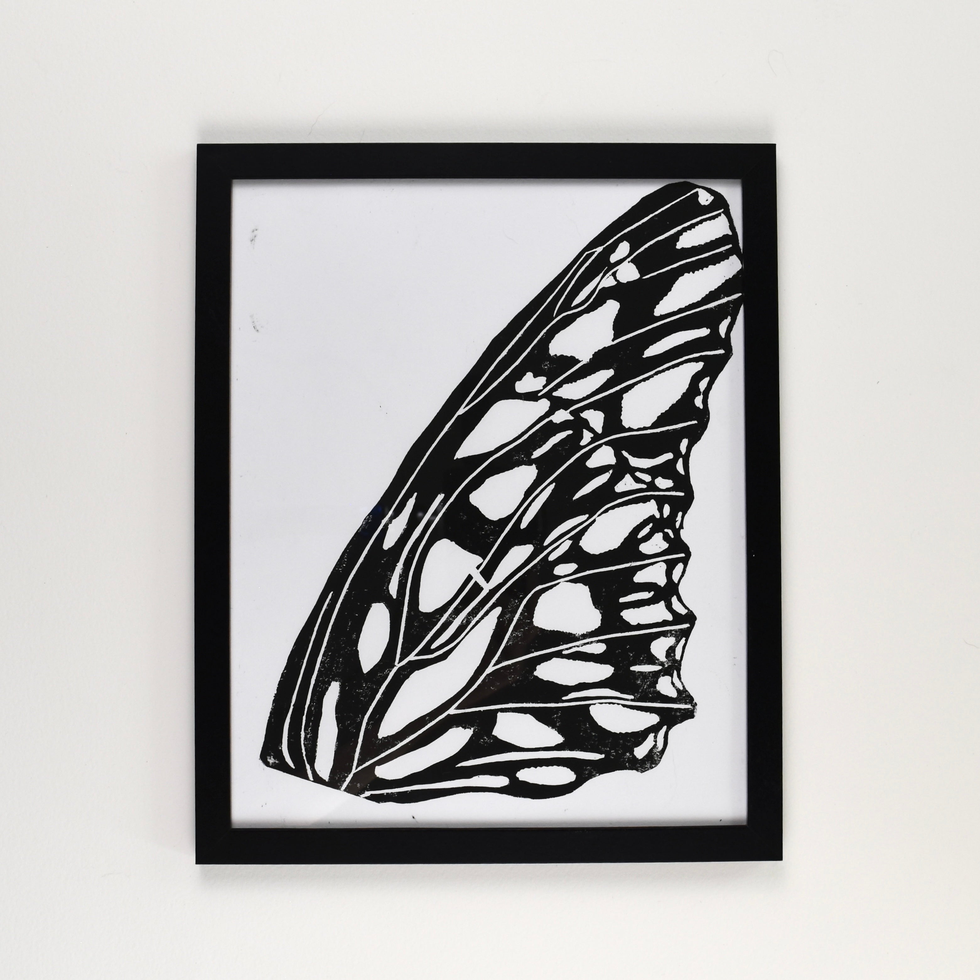 Hand-printed black and white linocut art of a gulf fritillary wing, framed